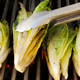 romaine hearts being turned on a grill
